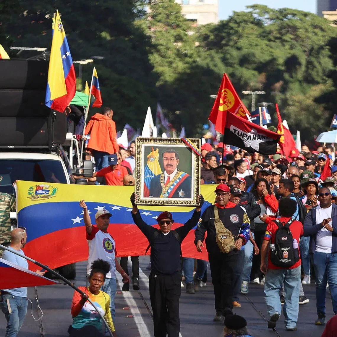 Several demonstrators, many of them public sector workers, held photos of Nicolas Maduro and his wife Cilia Flores.