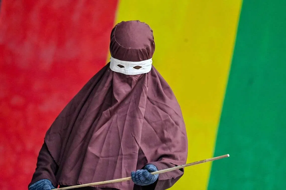 A member of Aceh's Sharia police wielding a rattan stick during a public flogging in Banda Aceh on April 7, 2026. A couple was publicly flogged in Indonesia's staunchly Islamic Aceh province on April 7 for having sex outside of marriage, in the country's only region to apply a version of Sharia law. 