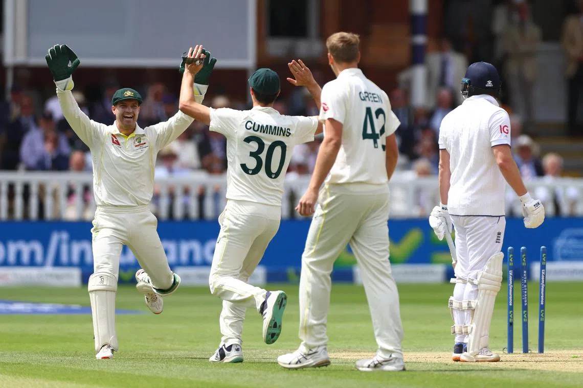 Australia's Alex Carey celebrating with Pat Cummins after running out England's Jonny Bairstow in the second Ashes Test at Lord's.