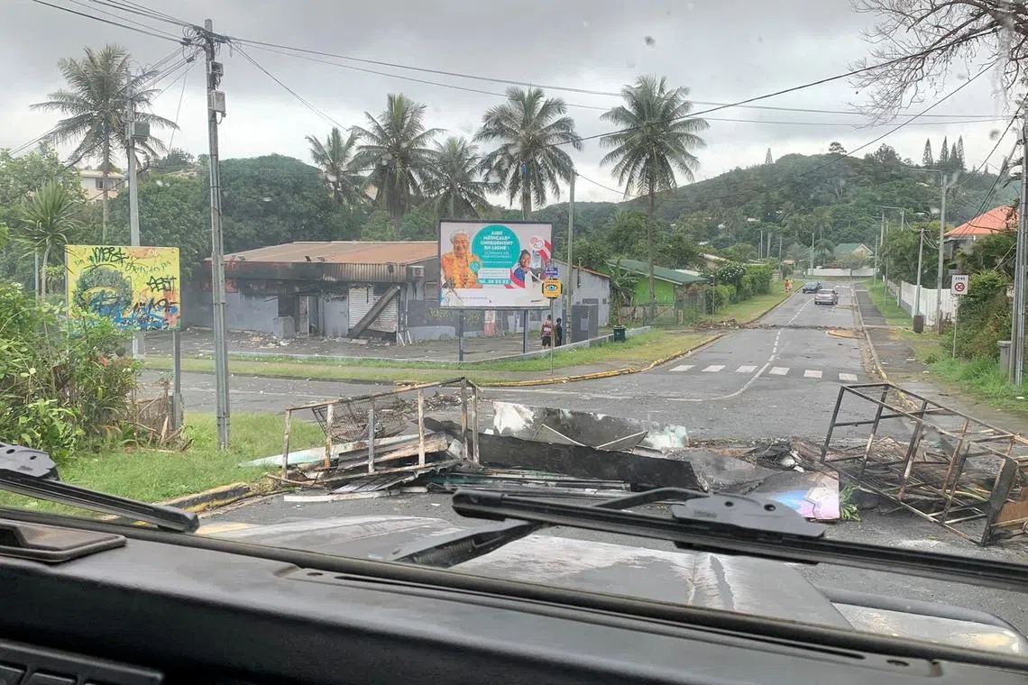 FILE PHOTO: A road is barricaded by rioters as they protest against plans to allow more people to take part in local elections in the French-ruled territory, which indigenous Kanak protesters reject, in Noumea, New Caledonia, May 15, 2024, in this picture obtained from social media. Lilou Garrido Navarro Kherachi/via REUTERS/File Photo