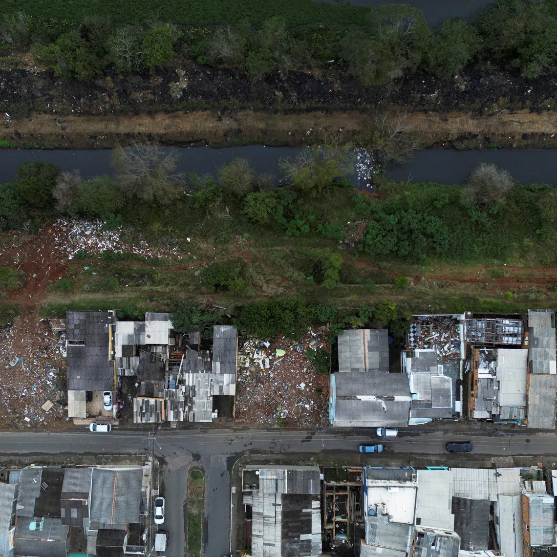FILE PHOTO: A drone view of homes and empty plots along the banks of the Sarandi Stream, where houses were demolished for the Sarandi levee expansion project following the devastating 2024 floods, in Porto Alegre, Brazil, June 8, 2026. REUTERS/Diego Vara/File Photo