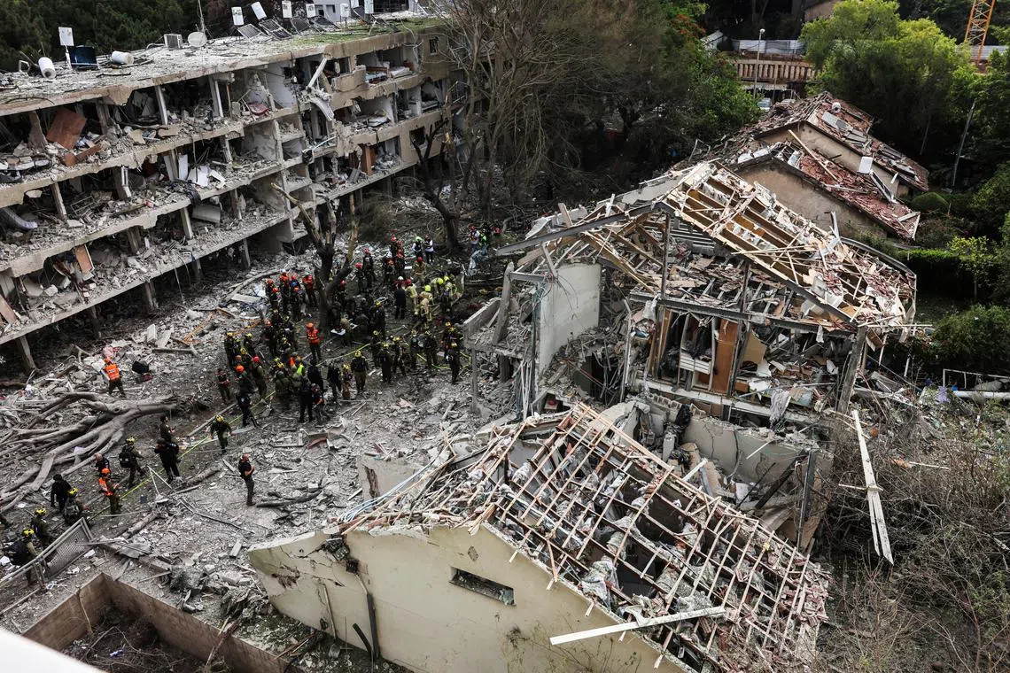 Rescuers and security personnel at the impacted site after a missile attack from Iran, amid the Iran-Israel conflict in Tel Aviv, Israel on June 22. 