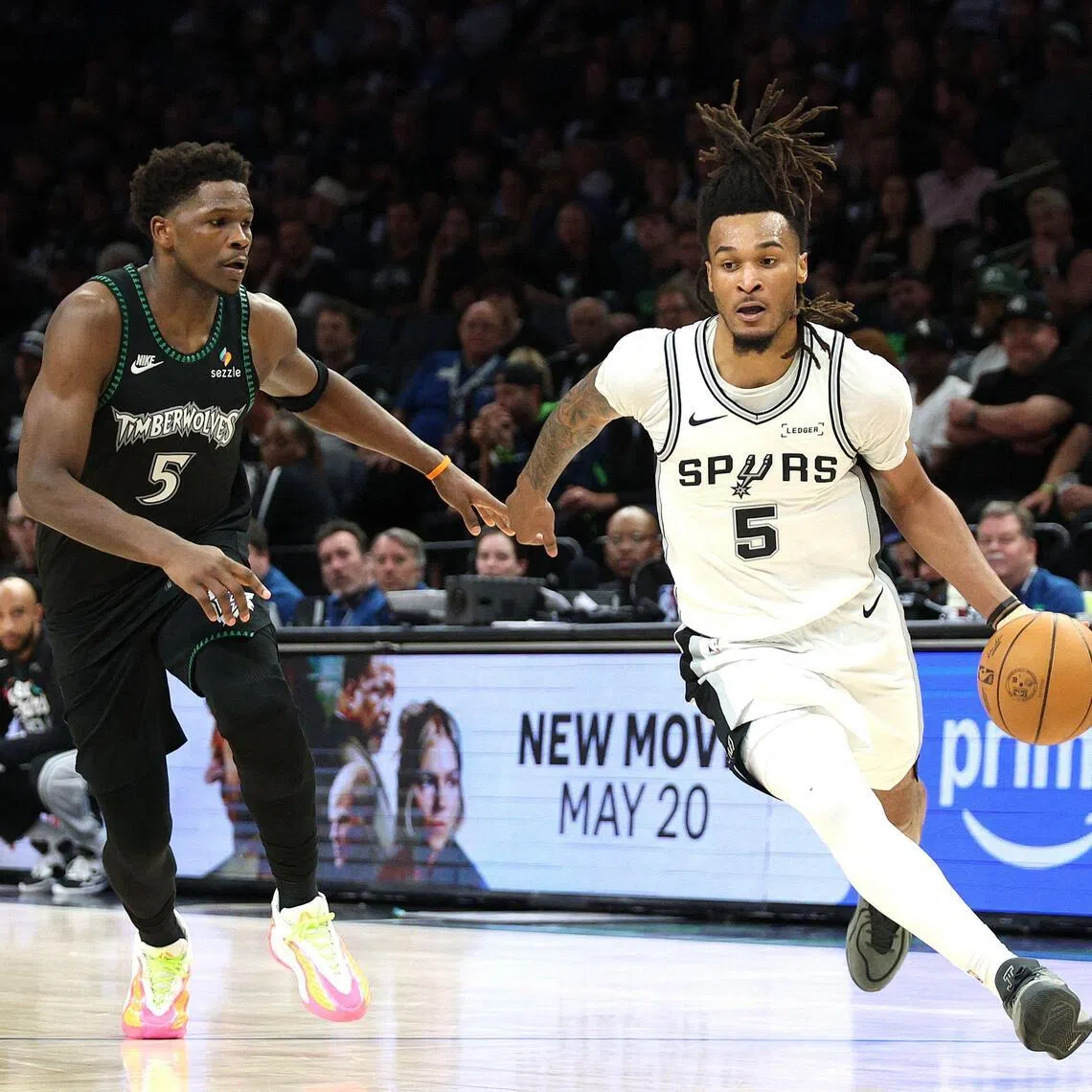 Stephon Castle of the San Antonio Spurs drives around Anthony Edwards of the Minnesota Timberwolves during the fourth quarter in Game 6.