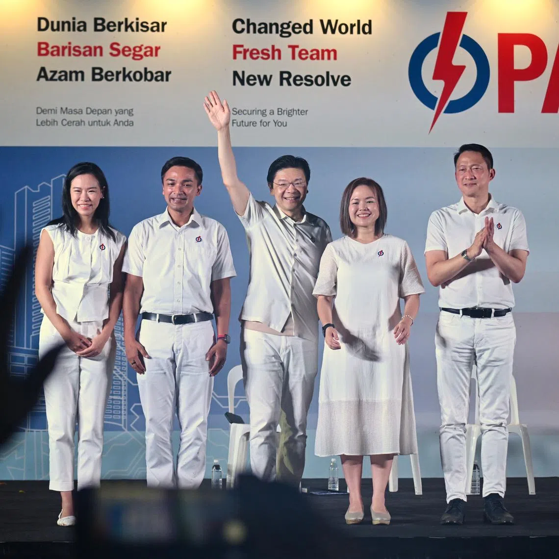 PM Lawrence Wong (centre) with Sengkang candidates (from left) Bernadette Giam, Elmie Nekmat, Theodora Lai, and Lam Pin Min at the rally at North Vista Secondary School on May 1.