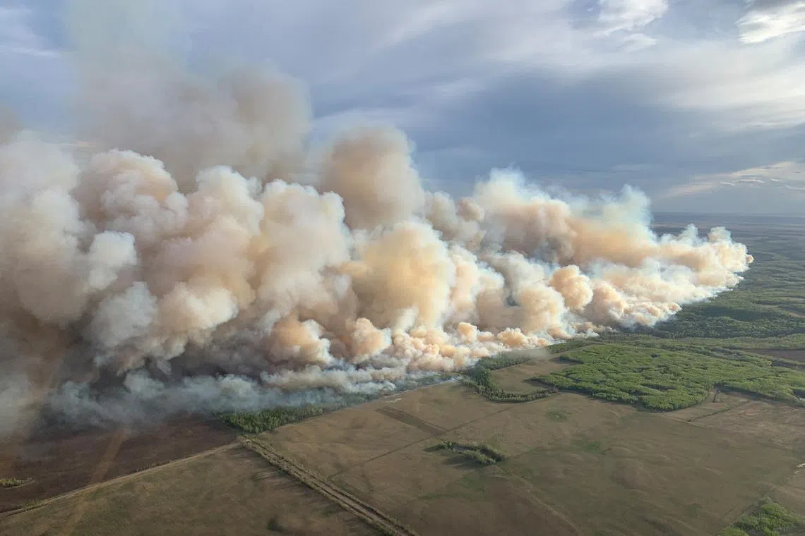 FILE PHOTO: Smoke rises from mutual aid wildfire GCU007 in the Grande Prairie Forest Area near TeePee Creek, Alberta, Canada May 10, 2024. Alberta Wildfire/Handout via REUTERS/File Photo