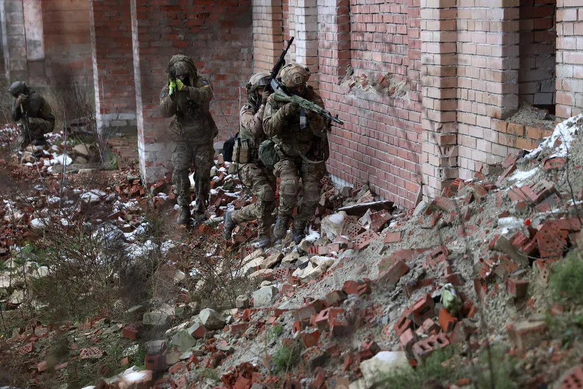 Ukrainian soldiers train in an abandoned brick building in Sloviansk, in Ukraine's Donetsk region, before heading back to the front line.