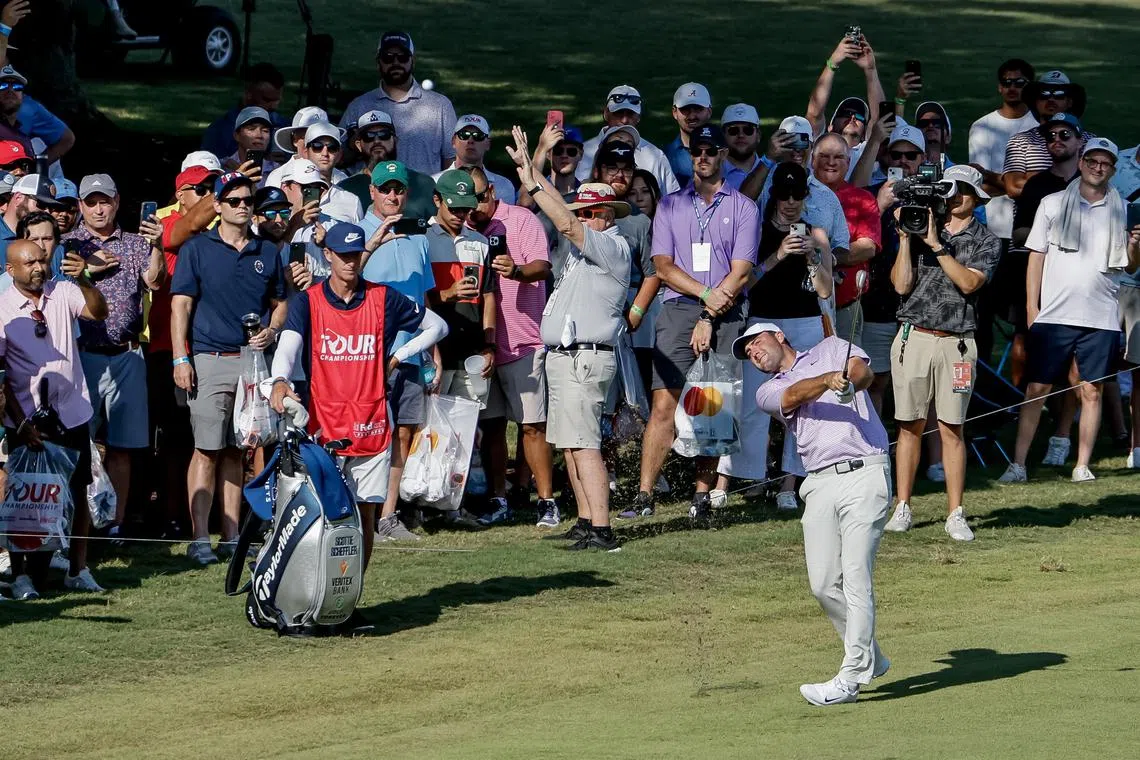 Scottie Scheffler makes his approach shot to the 16th green during the first round of the 2024 Tour Championship.