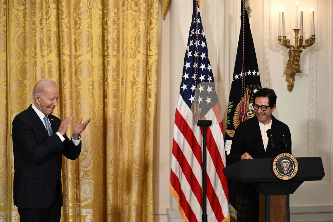 US President Joe Biden applauds as US actor Ke Huy Quan speaks before a screening of “American Born Chinese” in celebration of Asian American, Native Hawaiian, and Pacific Islander Heritage Month, in the East Room of the White House in Washington, DC, on May 8, 2023. (Photo by Brendan SMIALOWSKI / AFP)