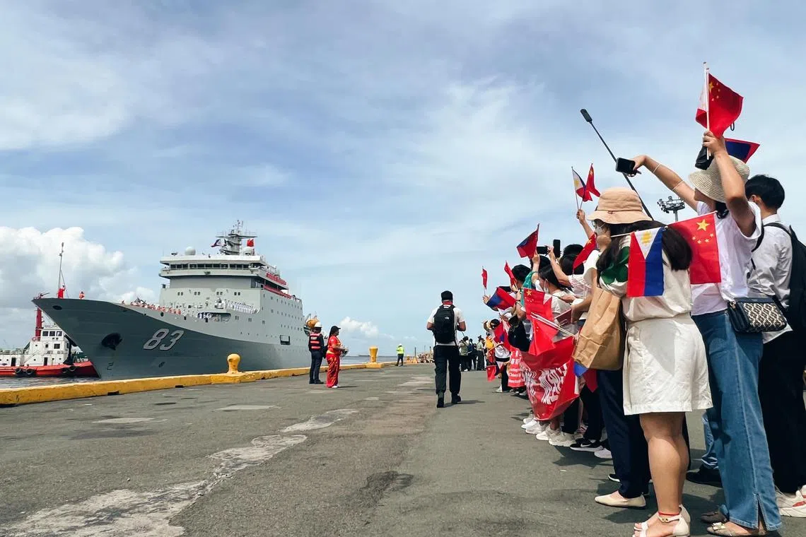 Chinese nationals and members of the Filipino-Chinese community welcome the Chinese naval training ship Qi Jiguang at the Port of Manila, Philippines on June 14, 2023.