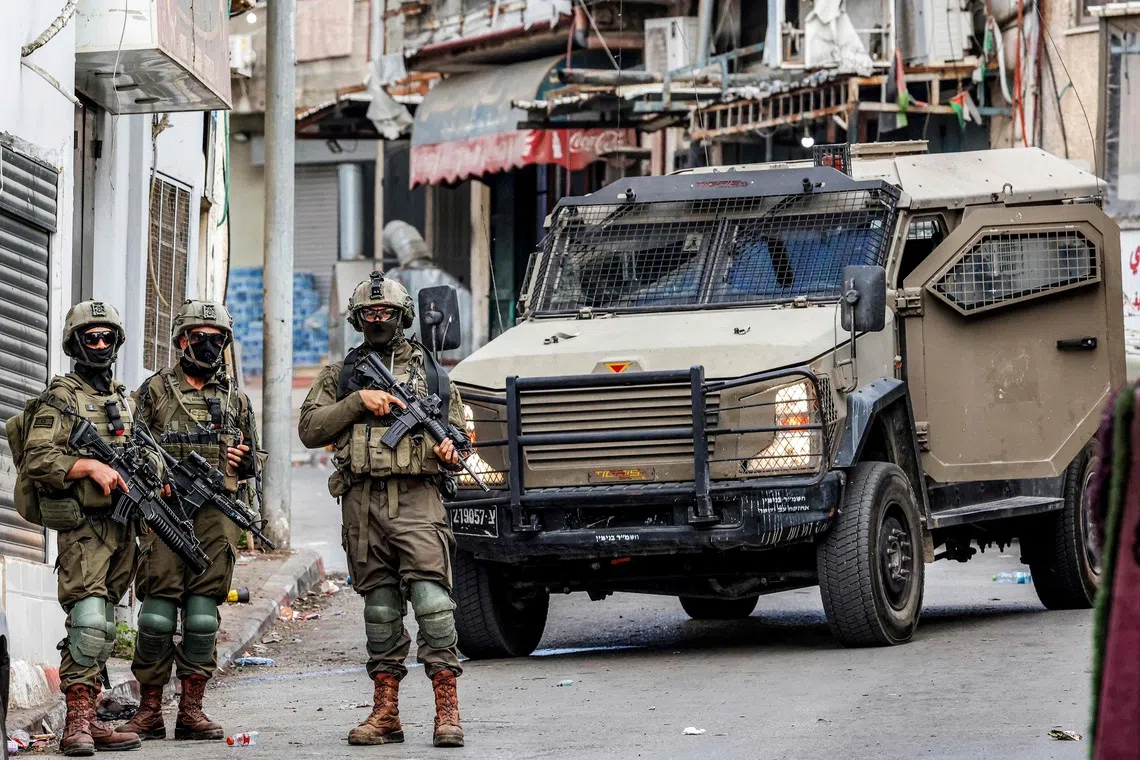 Israeli army soldiers deploy during a military operation at the Jalazun camp for Palestinian refugees north of Ramallah in the Israeli-occupied West Bank on Oct 14, 2026.
