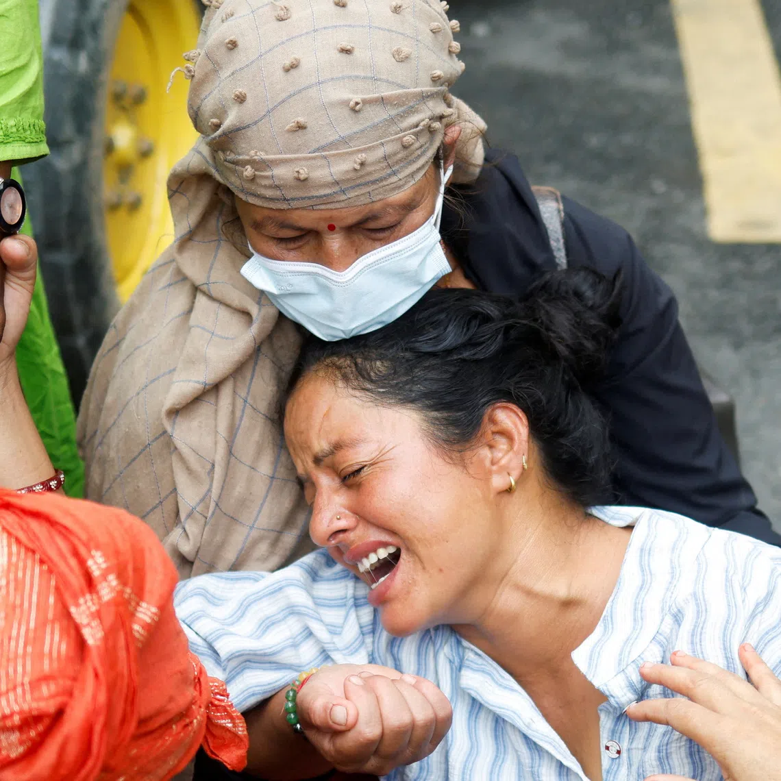 Muna Khadka, mother of Aayush Khadka, 21, who lost his life during the deadly flash floods and a mudslide, mourns outside a cremation ground, in Chitwan, Nepal, August 31, 2026. REUTERS/Adnan Abidi