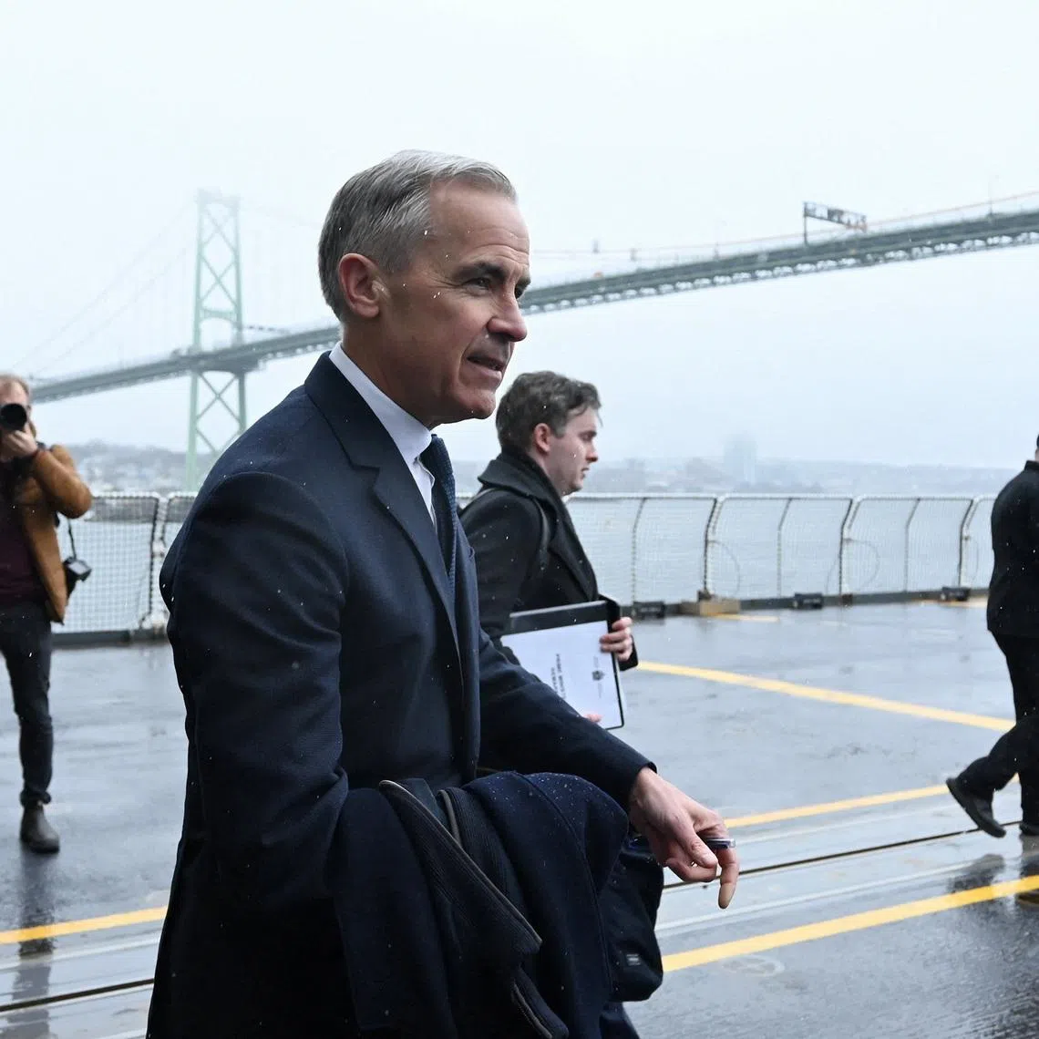 Canada's Prime Minister Mark Carney walks on the flight deck of HMCS Margaret Brooke at HMC Dockyard in Halifax, Nova Scotia, Canada March 26, 2026.  REUTERS/Ingrid Bulmer
