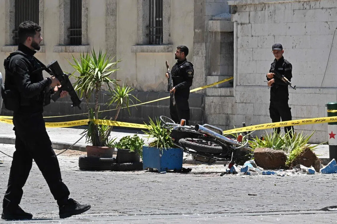 Security personnel standing guard near the Four Seasons Hotel, following two blasts nearby in Damascus on July 7, 2026.