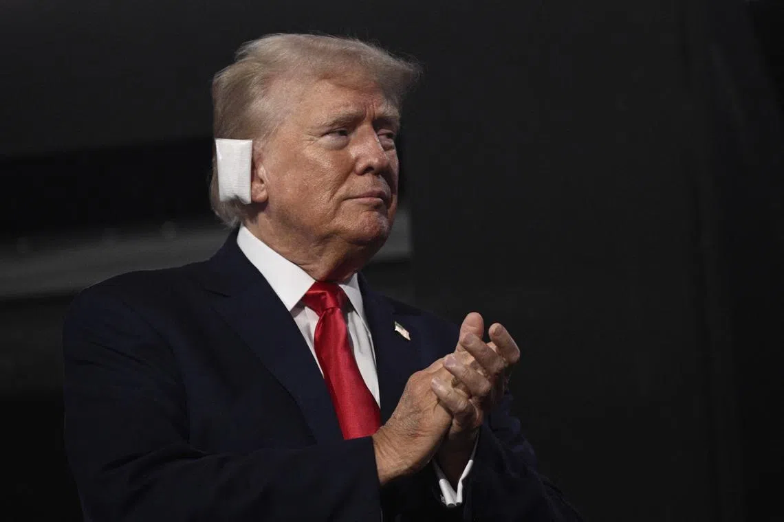 US former President Donald Trump, sports a bandage on his ear after being wounded in an assassination attempt, at the first day of the 2024 Republican National Convention on July 15.