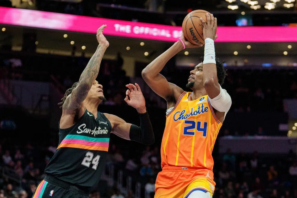 Brandon Miller of the Charlotte Hornets shooting the ball over Devin Vassell of the San Antonio Spurs during the Hornets' 111-106 NBA win at Spectrum Center on Jan 31, 2026 in Charlotte, North Carolina.