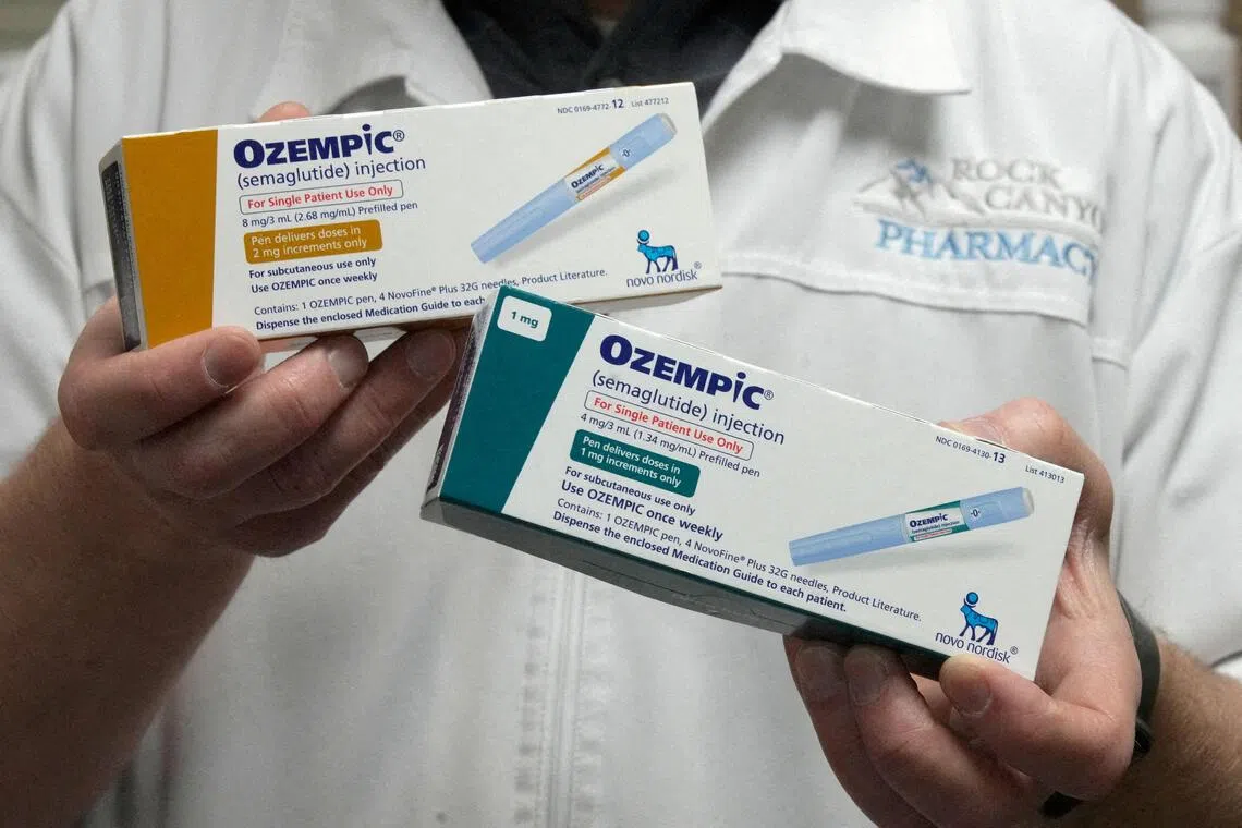 FILE PHOTO: A pharmacist displays boxes of Ozempic, a semaglutide injection drug used for treating type 2 diabetes made by Novo Nordisk, at Rock Canyon Pharmacy in Provo, Utah, U.S. March 29, 2023. REUTERS/George Frey/File Photo