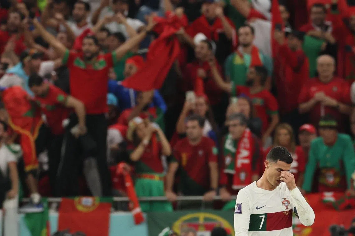 Portugal's forward #07 Cristiano Ronaldo looks dejected as he leaves the pitch after Morocco won the Qatar 2022 World Cup quarter-final football match between Morocco and Portugal at the Al-Thumama Stadium in Doha on December 10, 2022. (Photo by KARIM JAAFAR / AFP)