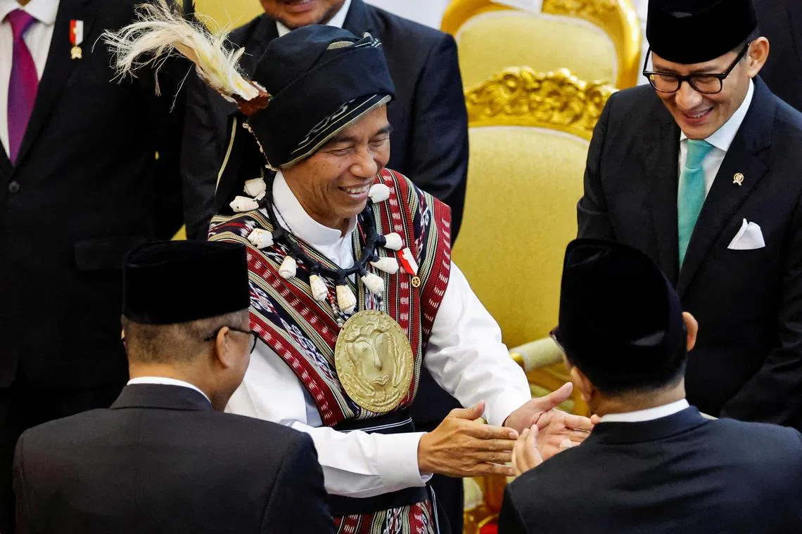 Indonesian President Joko Widodo, wearing traditional attire from Tanimbar Archipelago of Maluku province, greets the parliament members after delivering his State of the Nation Address ahead of the country's Independence Day, at the parliament building in Jakarta, Indonesia, August 16, 2023. REUTERS/Willy Kurniawan/Pool     TPX IMAGES OF THE DAY     