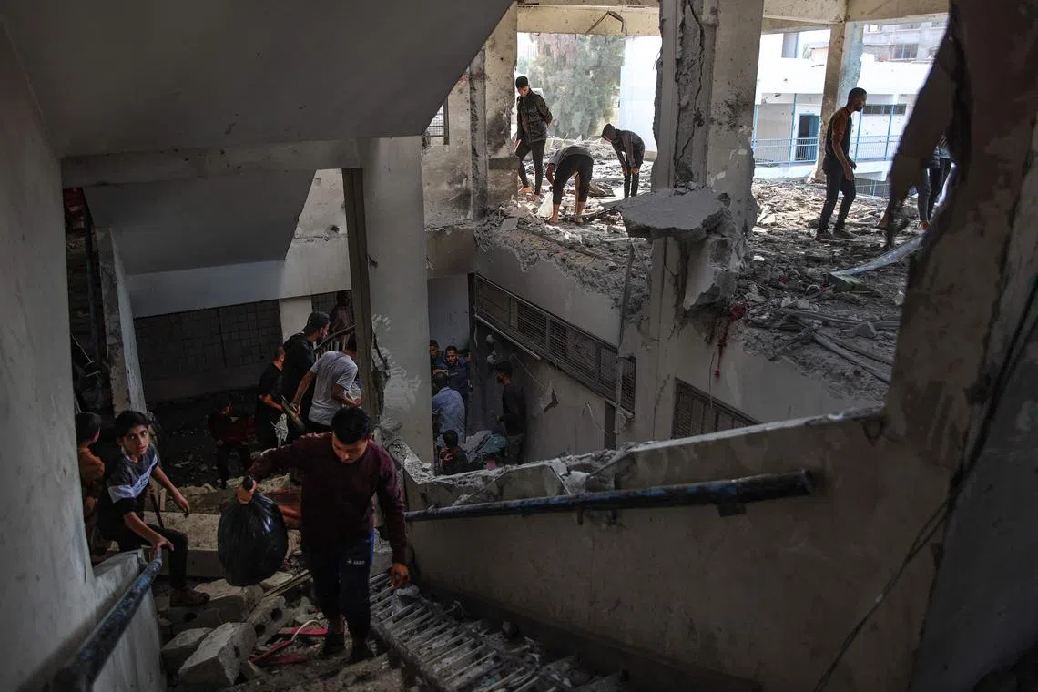 Palestinians checking the damage after an Israeli strike at a UN school-turned-shelter in the Al-Shati refugee camp, on Nov 7.