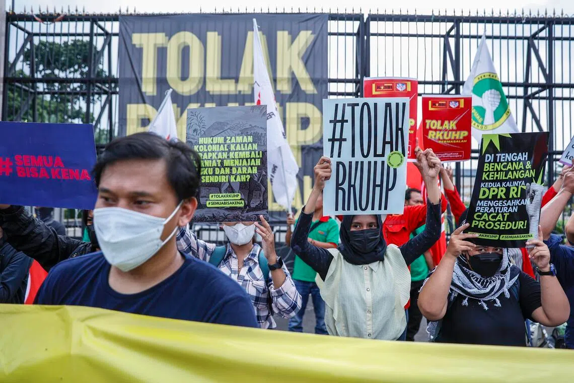 Activists protesting outside Indonesia's Parliament in December 2022 as a new criminal code is set to be passed.