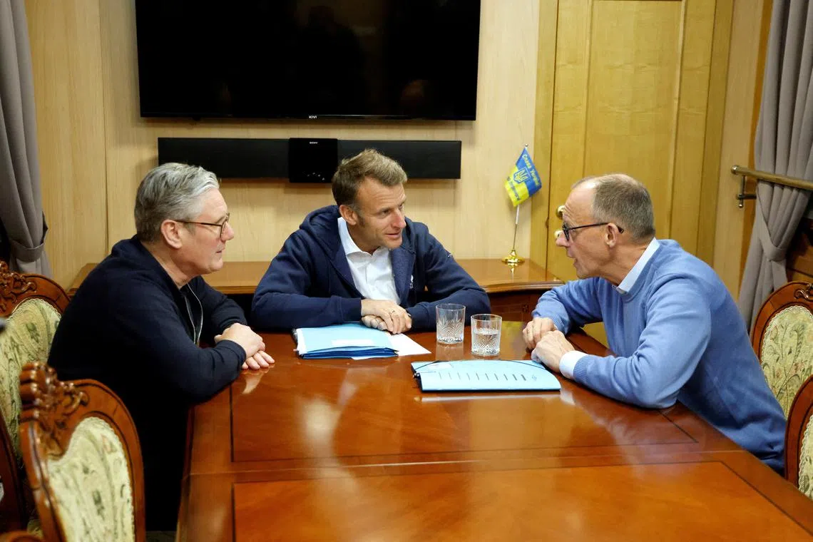 France's President Emmanuel Macron, Britain's Prime Minister Keir Starmer and German Chancellor Friedrich Merz hold a trilateral meeting on board a train to Ukraine, in an undisclosed loaction in Ukraine, May 9, 2025. LUDOVIC MARIN/Pool via REUTERS