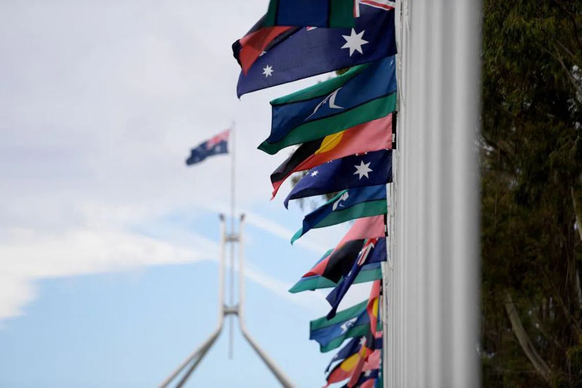 Australian Aboriginal and Torres Strait Islander flags are pictured in front of Australian Parliament House, during The Voice referendum in Canberra, Australia, October 14, 2023. REUTERS/Tracey Nearmy