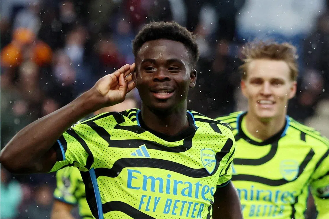 Arsenal's Bukayo Saka celebrates scoring their third goal.