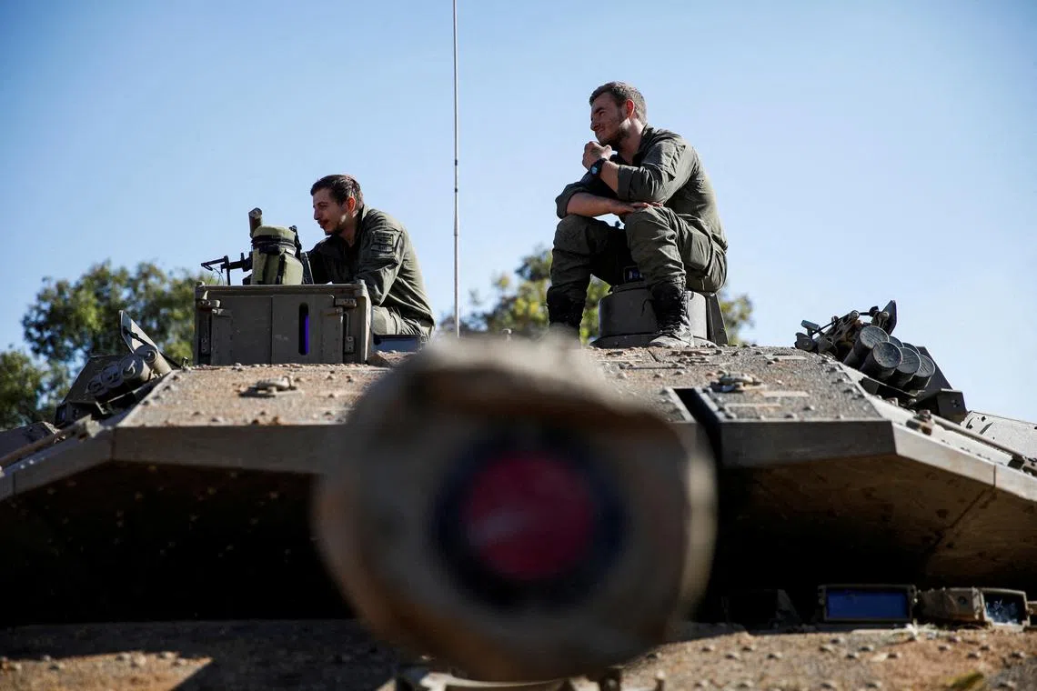 FILE PHOTO: Israeli soldiers sit on a military vehicle near Israel's border with Lebanon, following the ceasefire between Israel and Iran-backed group Hezbollah, in northern Israel, December 5, 2024. REUTERS/Shir Torem/File Photo