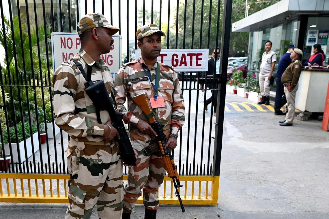 Guards standing outside the office building where Indian tax authorities raided the office of BBC, in New Delhi on Feb 15, 2023.