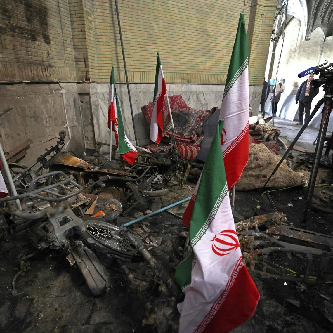 A videographer taking images of the wreckage at the Al-Aqsa Mosque that was damaged during recent public protests, in Tehran on Jan 21.