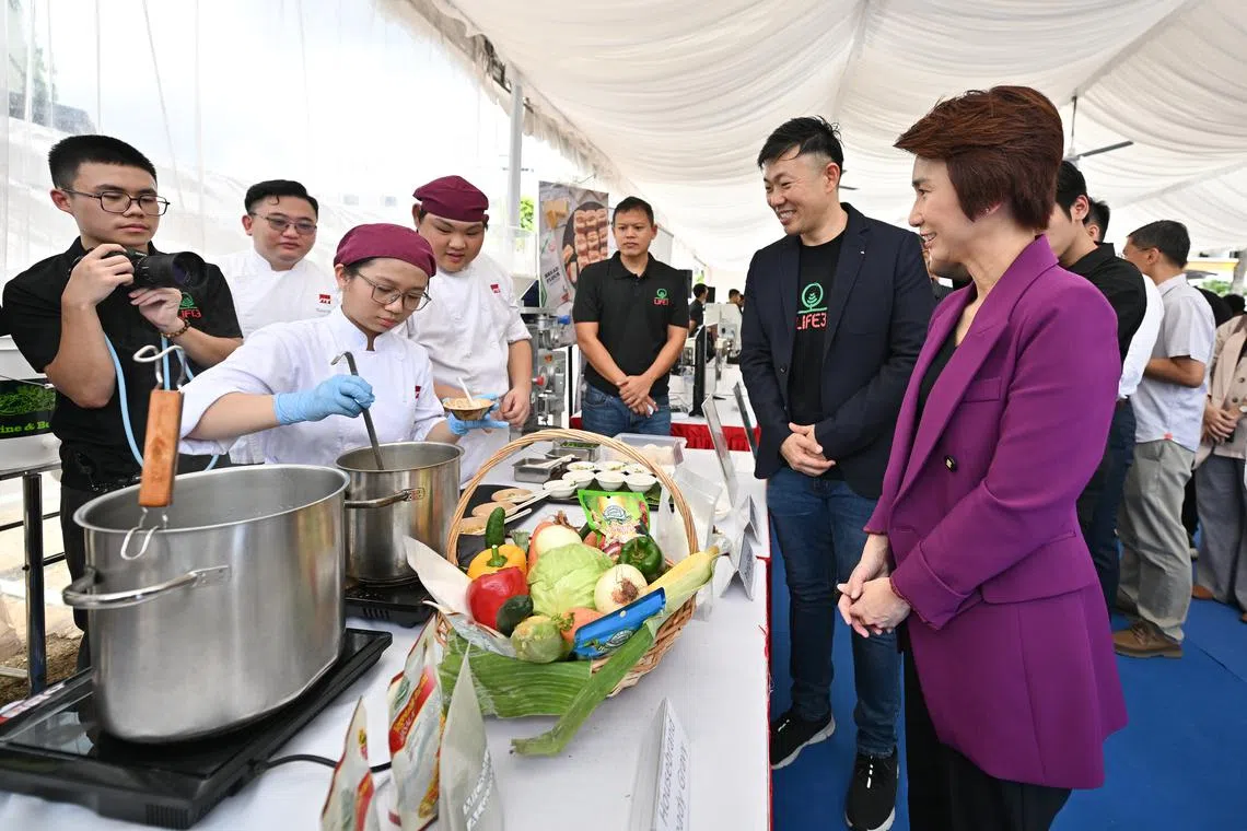 Minister of State for Trade and Industry Low Yen Ling (right) at the Life3 Food Tech Live Station during ground-breaking event for LUSH.