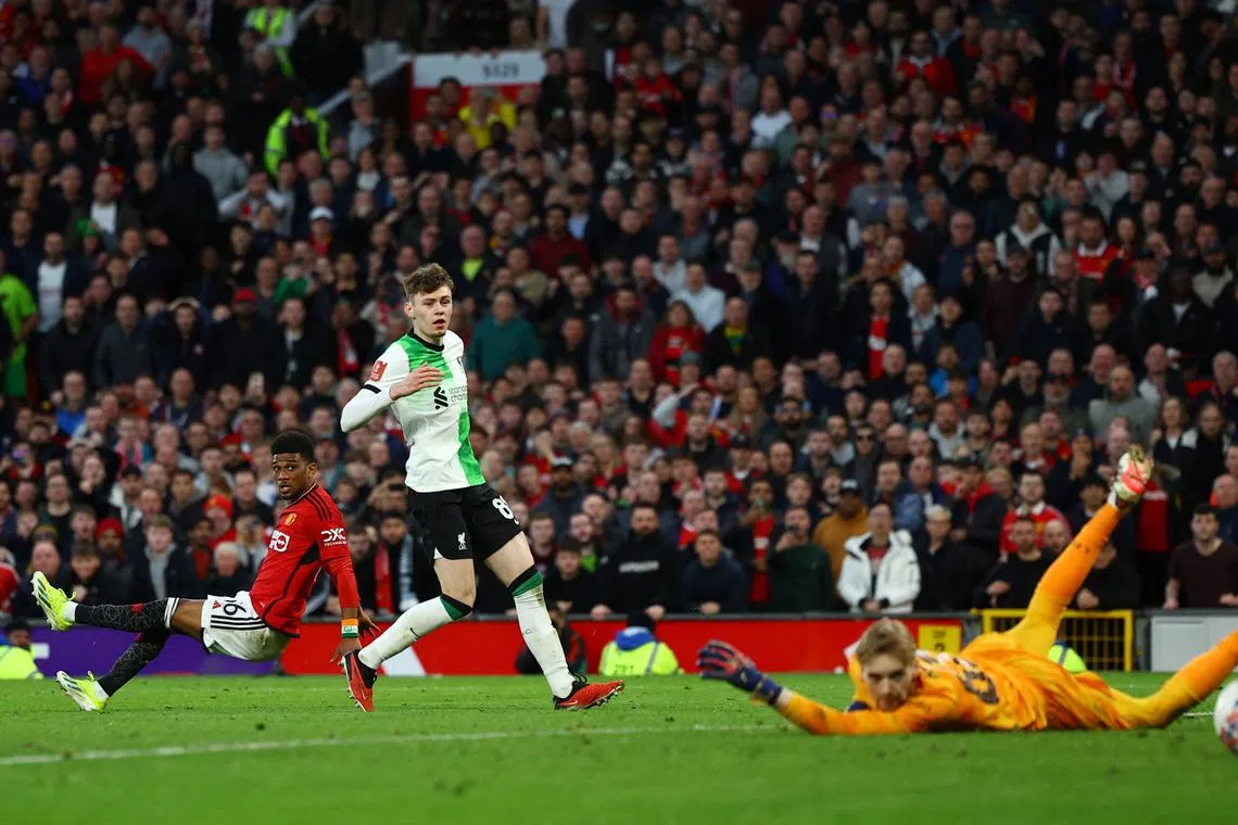 Soccer Football - FA Cup - Quarter Final - Manchester United v Liverpool - Old Trafford, Manchester, Britain - March 17, 2024 Manchester United's Amad Diallo scores their fourth goal past Liverpool's Caoimhin Kelleher REUTERS/Molly Darlington