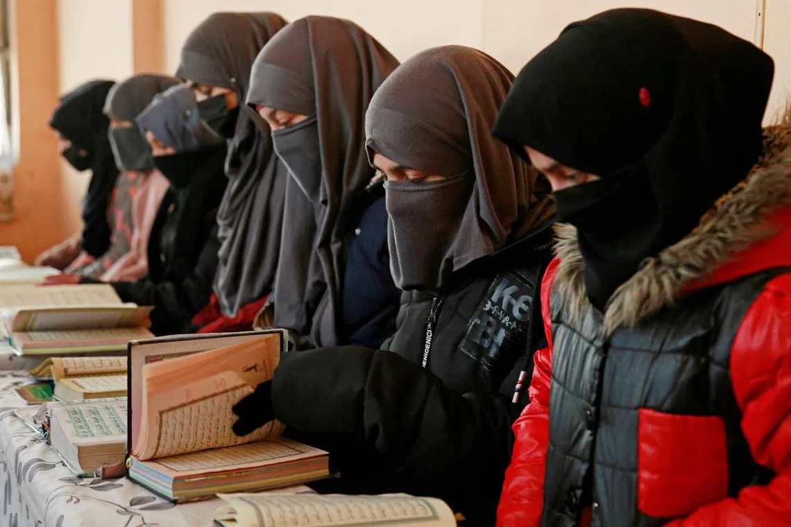 Afghan girls learn the holy Koran at a madrassa or an Islamic school on the outskirts of Kabul, on Feb 13, 2023.