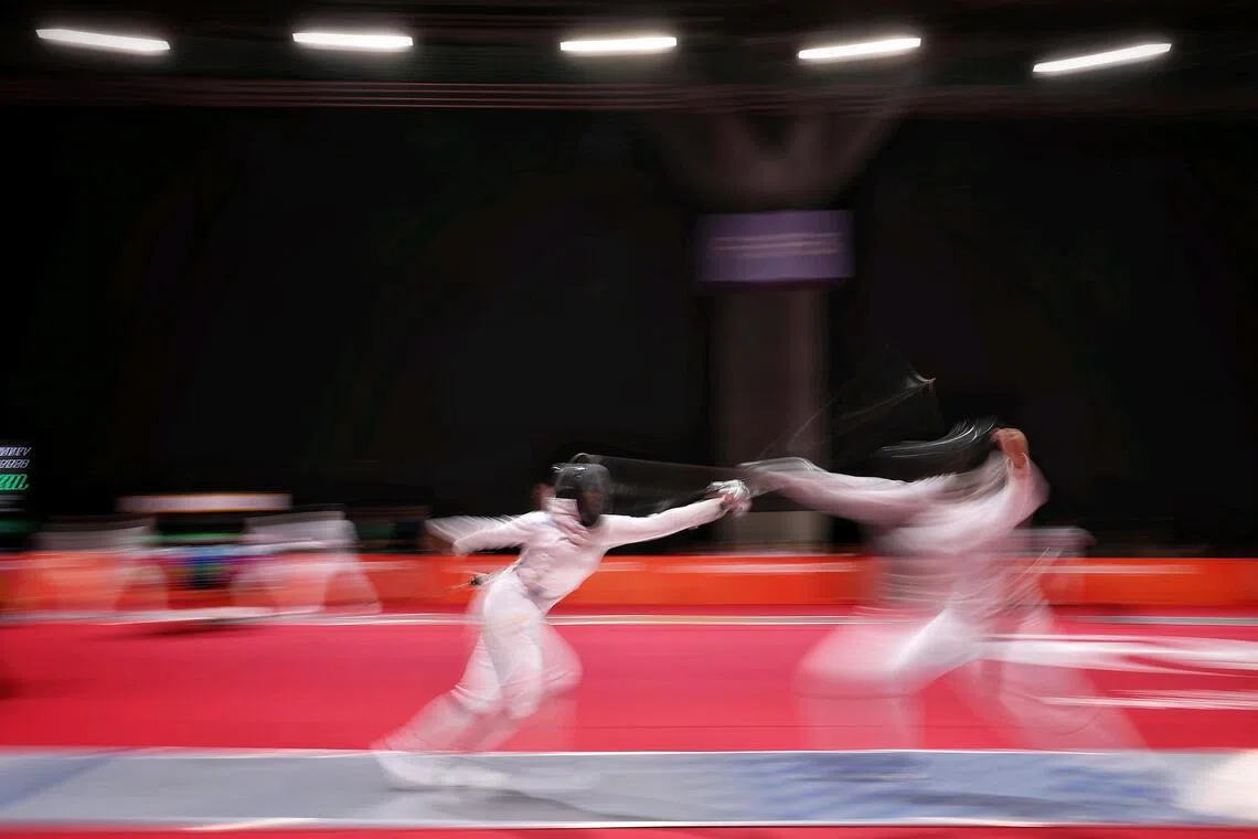 Elle Koh (left) of Singapore in action against Uzbekistan in the women's epee team quarter-final at the Aichi-Nagoya 2026 Asian Games in Aichi Sky Expo in Nagoya, Japan on Sept 25, 2026. ST PHOTO: KEVIN LIM pixag25