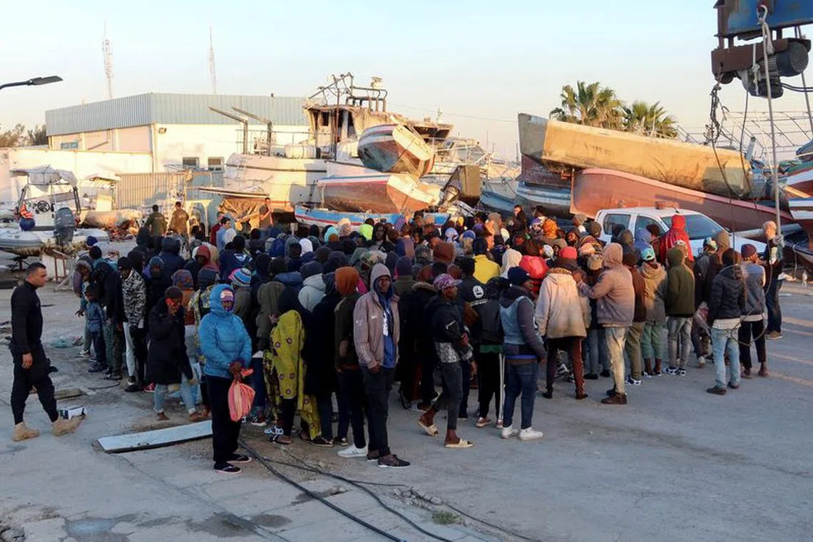 Migrants wait at Sfax port, after being stopped by Tunisian coast guard at sea during their attempt to cross to Italy, Tunisia April 26, 2023. REUTERS/Jihed Abidellaoui/File Photo
