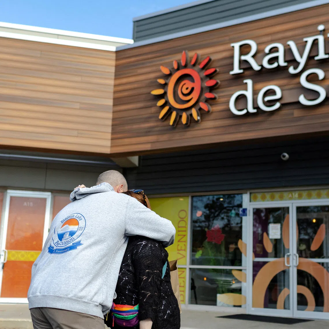Two parents embrace each other outside of the Rayito De Sol Spanish Immersion Daycare and Pre-School, where federal agents conducted an immigration raid that ended in a teacher being detained, in Chicago, Illinois, U.S., November 5, 2025. REUTERS/Jim Vondruska