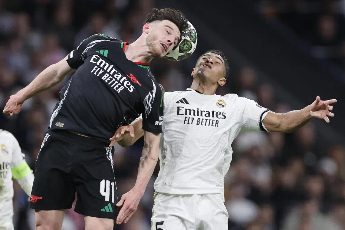 Arsenal's Declan Rice (left) and Real Madrid's Jude Bellingham vying for a header during the Champions League quarter-final, second leg in Madrid on April 16, 2025. 