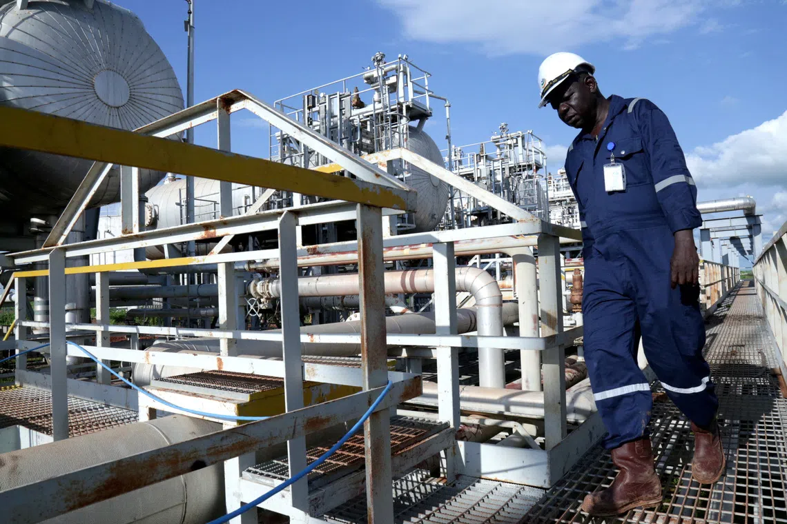 FILE PHOTO: A worker walks by an oil well at the Toma South oil field to Heglig, in Ruweng State, South Sudan August 25, 2018. Picture taken August 25, 2018. REUTERS/Jok Solomun/File Photo