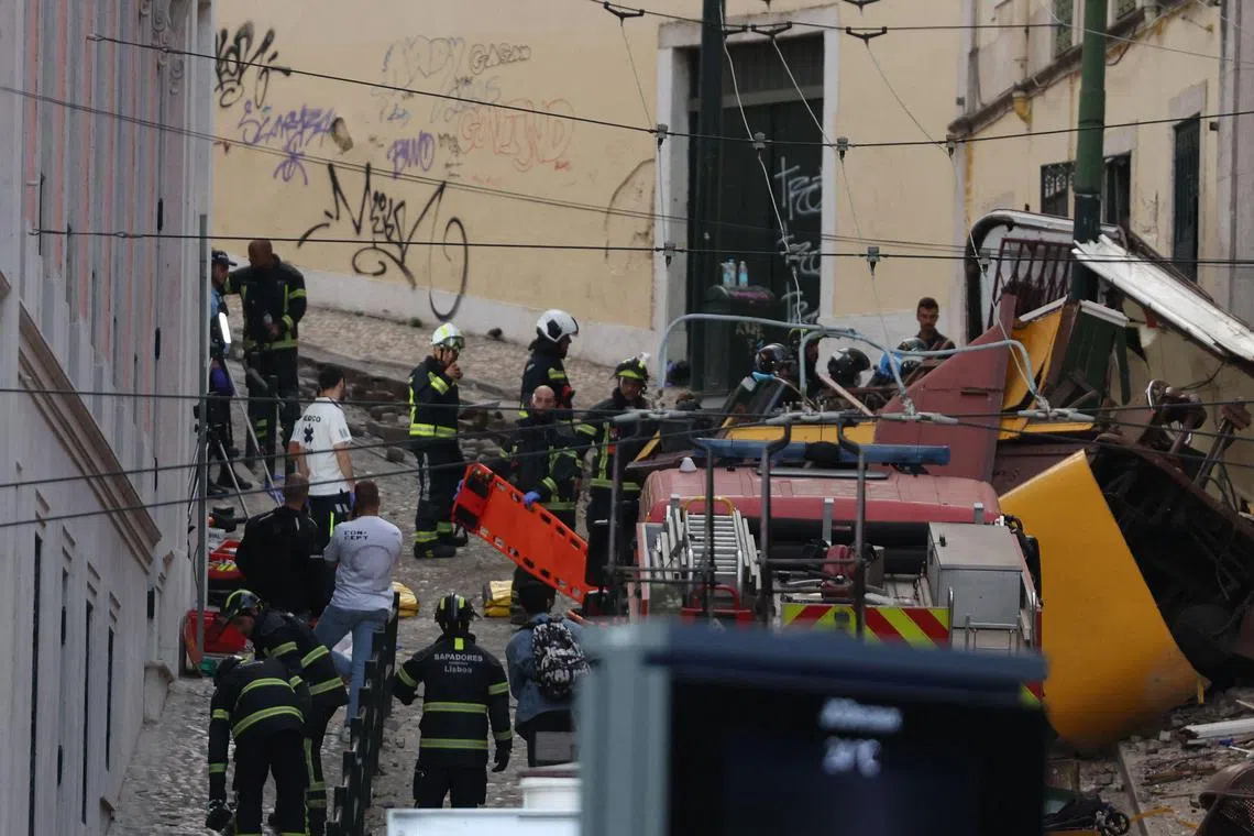 Police and firefighters working at the site of a funicular railway accident in Lisbon, on Sept 3.