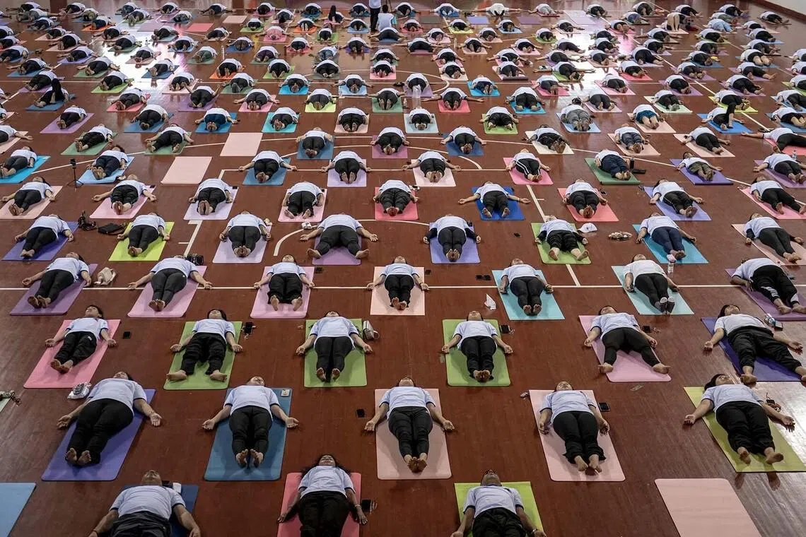 People take part in a yoga session to celebrate International Yoga Day at the Thuwanna Indoor Stadium in Yangon on June 21.