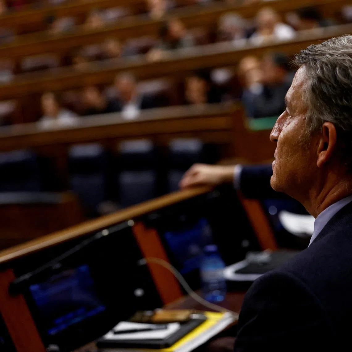 FILE PHOTO: Spain's opposition leader and People's Party president Alberto Nunez Feijoo attends a vote on a fiscal package extending a windfall tax on banks at Parliament, in Madrid, Spain, November 21, 2024. REUTERS/Susana Vera/File Photo