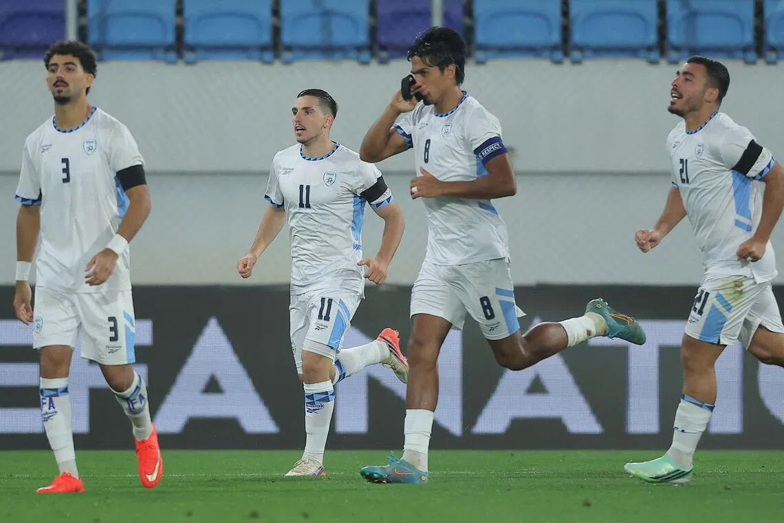 Israel’s midfielder Dor Peretz kissing his black armband as he celebrates scoring  during the Nations League match against Ireland on Oct 4.