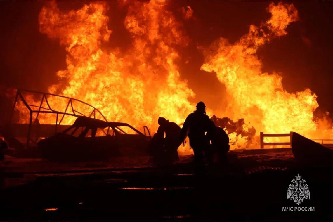 Rescuers are seen here pushing out a huge fire at a fuel station in Makhachkala, in the Russian republic of Dagestan.
