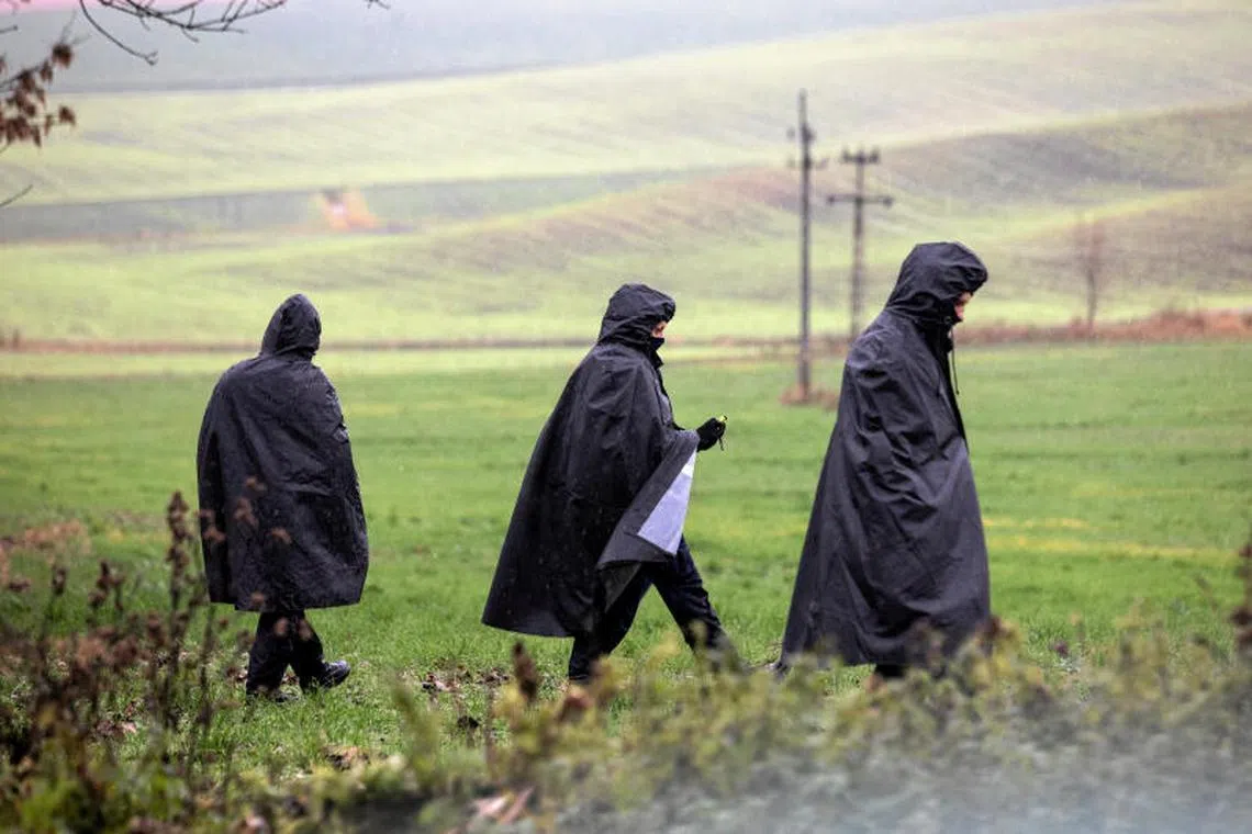 Police officers walking near the site of an explosion in Przewodow, a village in eastern Poland near the border with Ukraine, on Nov 16, 2022. 