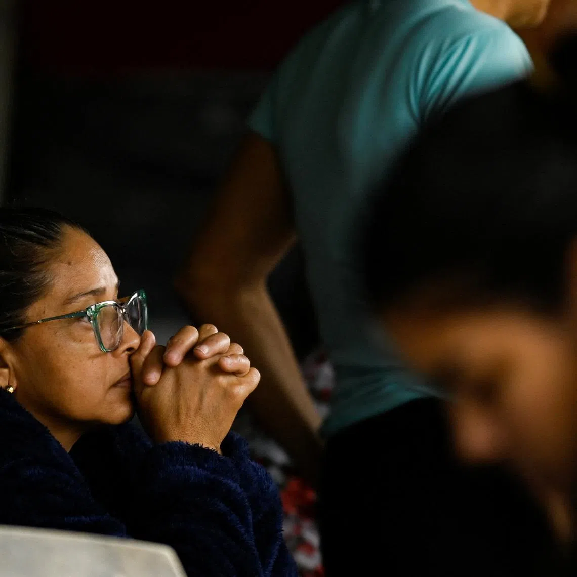 A family member of detainees waits outside El Rodeo jail, as Venezuela has freed Czech, Hungarian, Dutch and German citizens imprisoned in the country, part of a flow of prisoner releases, following the U.S. capture of Nicolas Maduro, in El Rodeo, Guatire, Venezuela, January 16, 2026. REUTERS/Maxwell Briceno