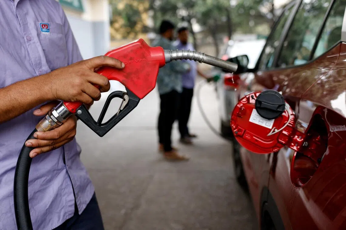 Fuel droplets fall from the nozzle after refuelling a car at a fuel station in Dhaka, Bangladesh, on March 10.