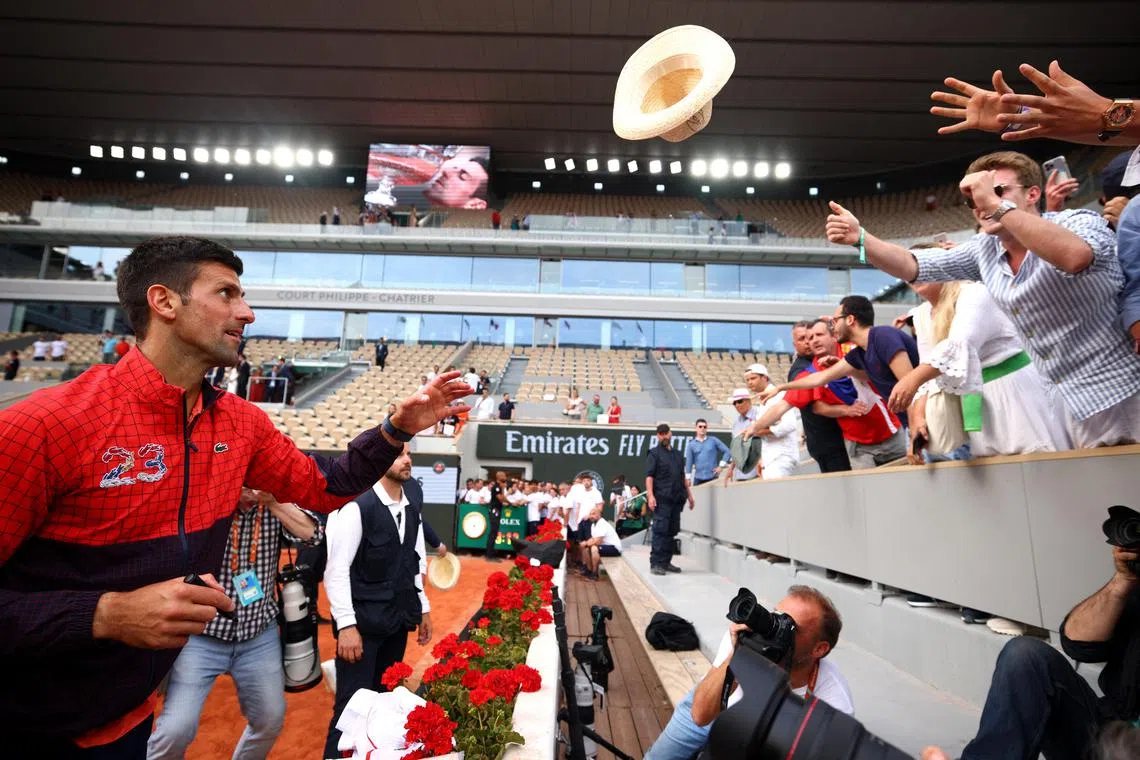 Serbia's Novak Djokovic celebrating with fans after winning the French Open on Sunday.