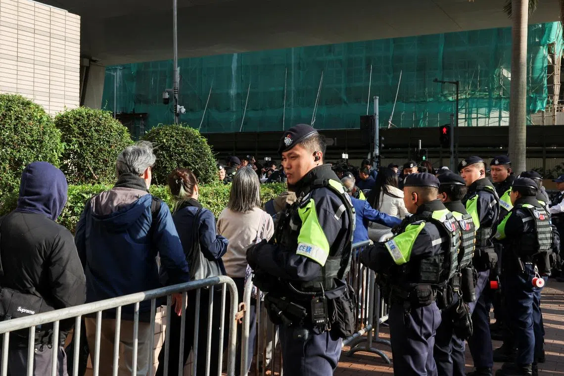People queue to enter the West Kowloon Magistrates' Courts building for sentencing in the national security collusion trial of Jimmy Lai, founder of the now-defunct pro-democracy newspaper Apple Daily, in Hong Kong, China, February 9, 2026. REUTERS/Tyrone Siu