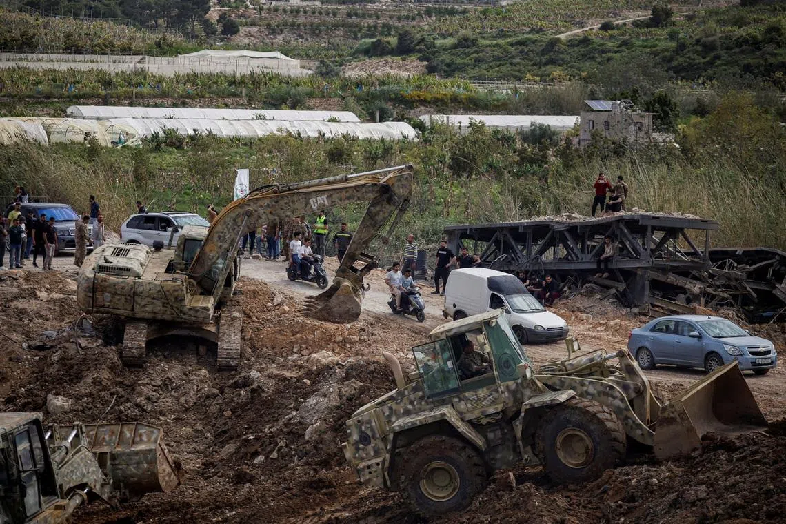 Heavy machinery operates to repair the bridge linking southern Lebanon to the rest of the country, in Qasmiyeh, Lebanon, on April 17.