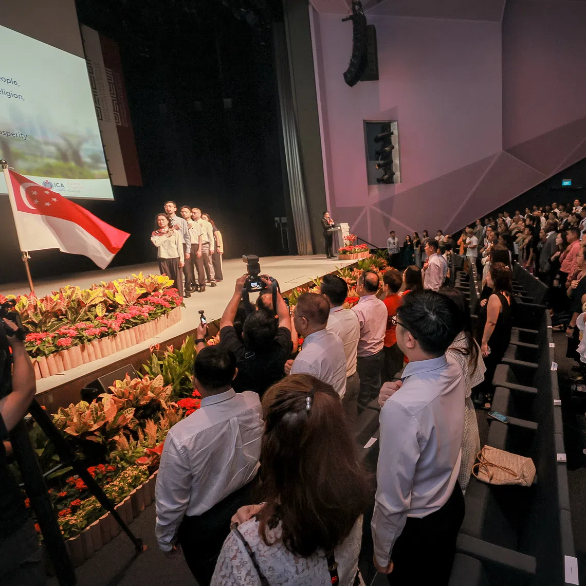 New Singapore citizens recite the National Pledge during the National Citizenship Ceremony on Aug 15.